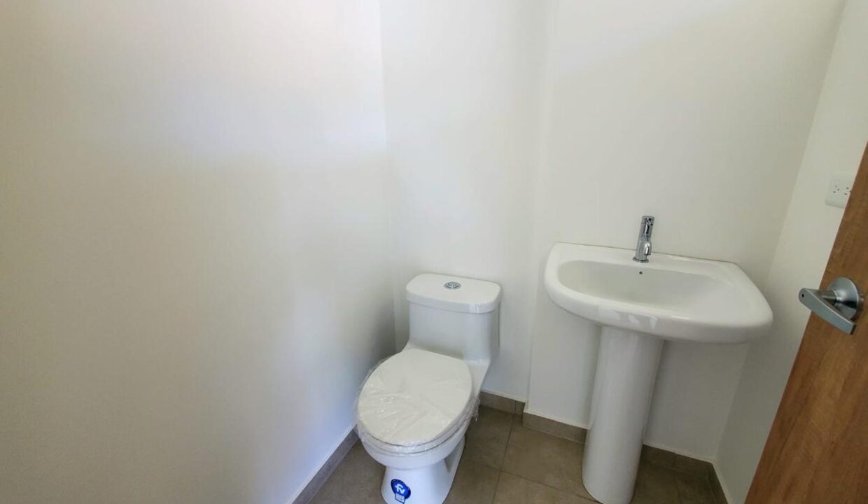 Medio baño social de la casa por estrenar en Pomasqui, Quito